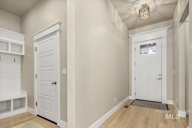 entrance foyer featuring baseboards and wood finished floors