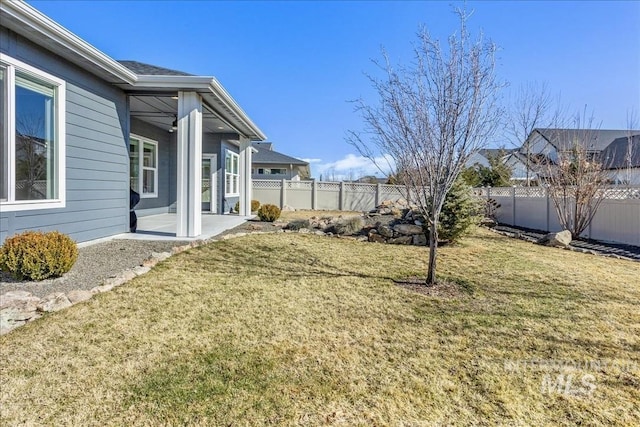 view of yard featuring a patio area and a fenced backyard