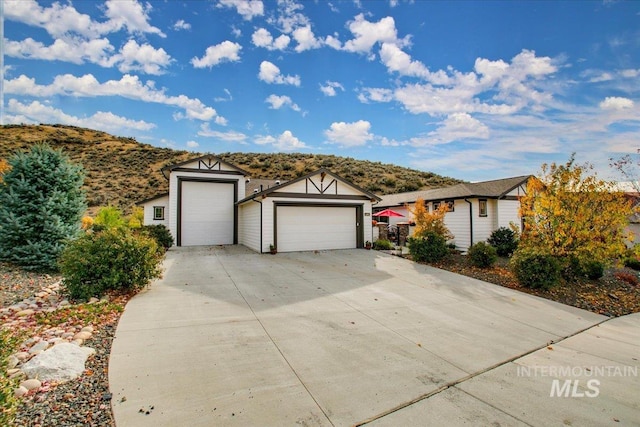 single story home with a mountain view and a garage