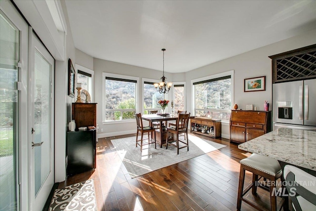 dining room with a chandelier and hardwood / wood-style floors