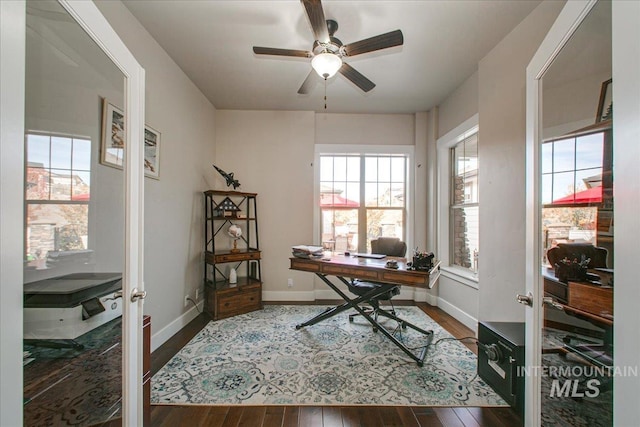 office space featuring french doors, dark hardwood / wood-style floors, and ceiling fan