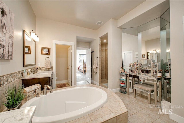 bathroom with vanity, tile patterned floors, and separate shower and tub