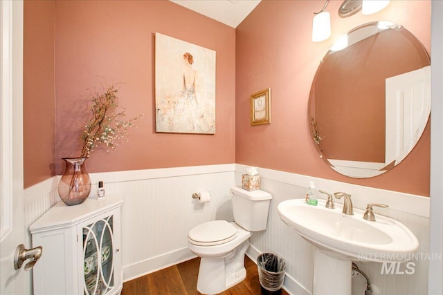 bathroom featuring hardwood / wood-style flooring and toilet