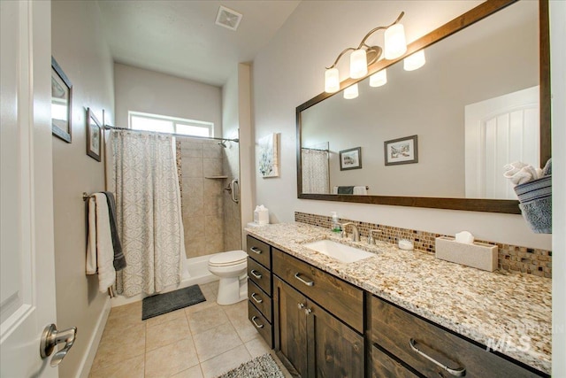 bathroom featuring vanity, tile patterned flooring, toilet, and walk in shower