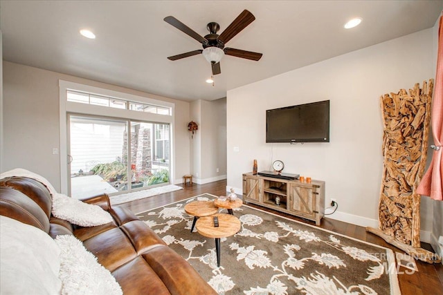 living room featuring dark hardwood / wood-style floors and ceiling fan