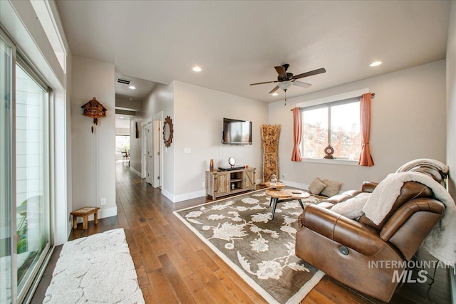 living room featuring hardwood / wood-style floors and ceiling fan