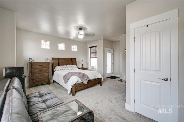 bedroom featuring light colored carpet and ceiling fan