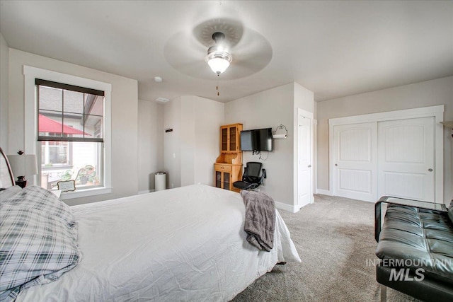 bedroom with a closet, carpet, and ceiling fan