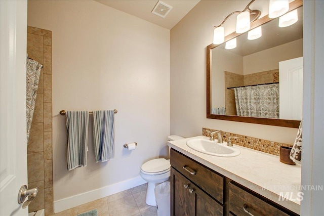 bathroom with toilet, a shower with curtain, vanity, and tile patterned flooring