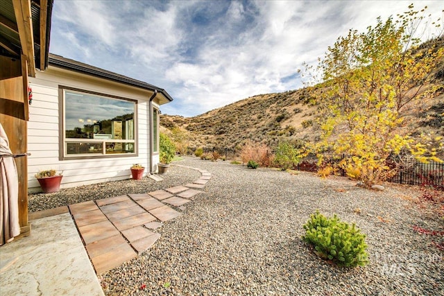 view of yard featuring a mountain view and a patio