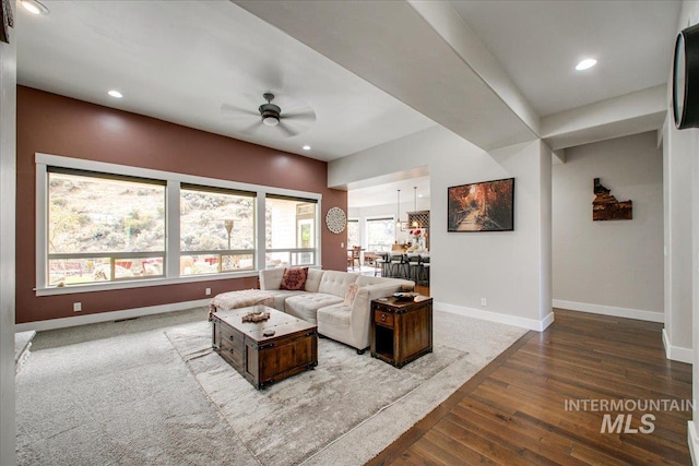 living room featuring dark hardwood / wood-style floors and ceiling fan