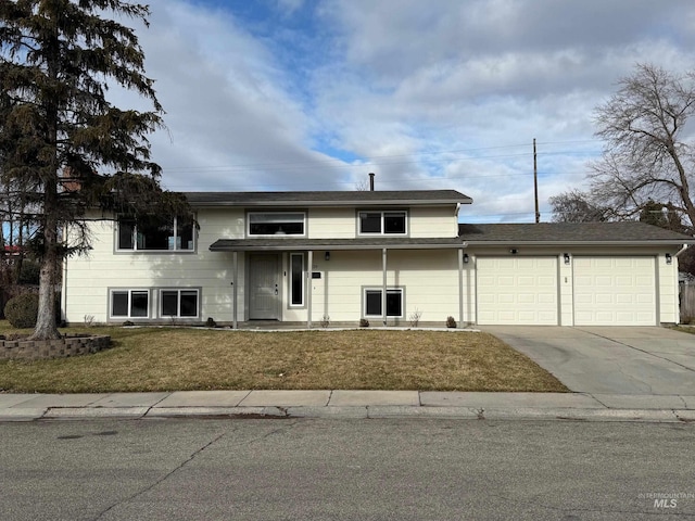 front facade featuring a front yard and a garage