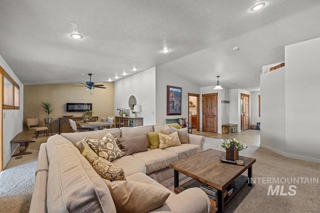 41 Knob Hill Dr, Mccall, ID 83638 - living area featuring light colored carpet, a ceiling fan, vaulted ceiling, a textured ceiling, and baseboards
