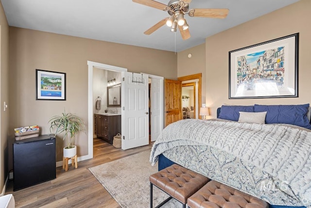 41 Knob Hill Dr, Mccall, ID 83638 - bedroom featuring wood finished floors, refrigerator, baseboards, ensuite bath, and ceiling fan