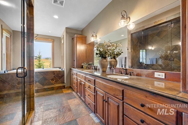 41 Knob Hill Dr, Mccall, ID 83638 - full bath featuring stone tile flooring, double vanity, a stall shower, and recessed lighting
