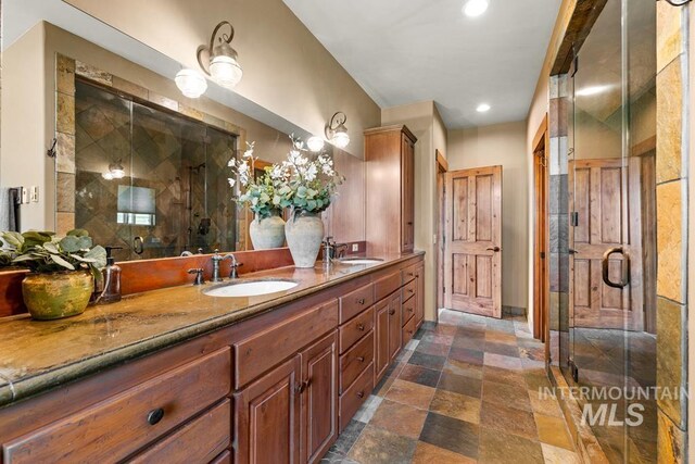 41 Knob Hill Dr, Mccall, ID 83638 - full bathroom featuring double vanity, stone finish floors, a shower stall, recessed lighting, and baseboards