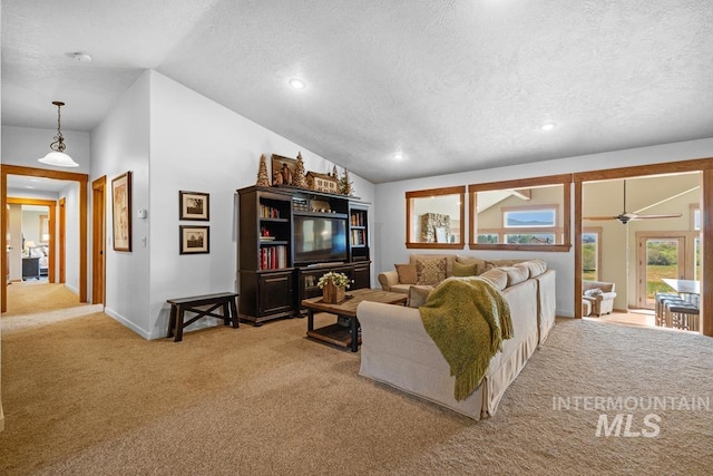 41 Knob Hill Dr, Mccall, ID 83638 - living room featuring a textured ceiling, light colored carpet, vaulted ceiling, recessed lighting, and baseboards