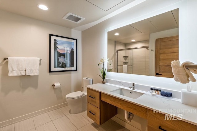 bathroom with toilet, vanity, visible vents, baseboards, and a stall shower