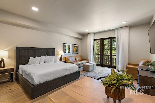 bedroom featuring access to exterior, light wood-type flooring, and recessed lighting