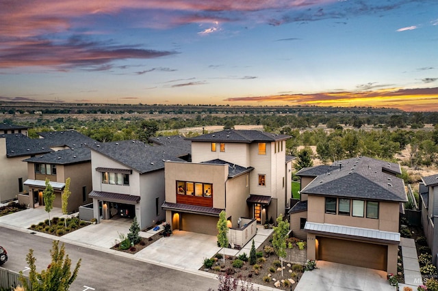 6799 E Warm Springs Ave, Boise, ID 83716 - view of front facade featuring an attached garage, driveway, stucco siding, and a residential view