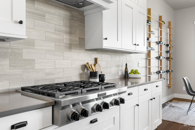 6799 E Warm Springs Ave, Boise, ID 83716 - kitchen with stainless steel gas stovetop, white cabinets, and tasteful backsplash