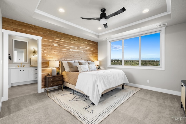 6799 E Warm Springs Ave, Boise, ID 83716 - bedroom with wooden walls, a tray ceiling, recessed lighting, light carpet, and ensuite bath