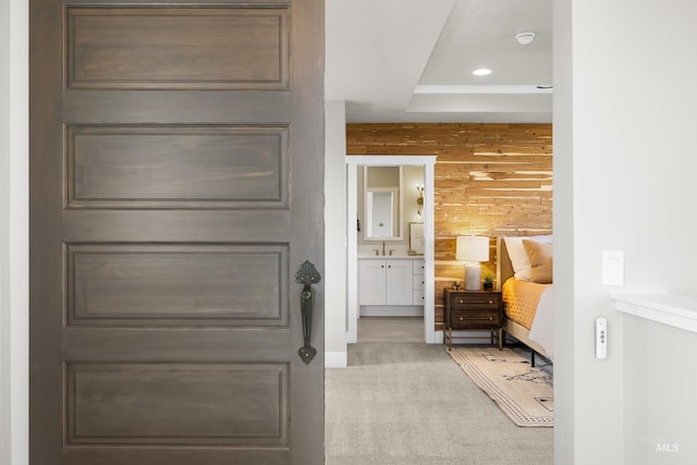 6799 E Warm Springs Ave, Boise, ID 83716 - hall with carpet floors, wood walls, a sink, and recessed lighting