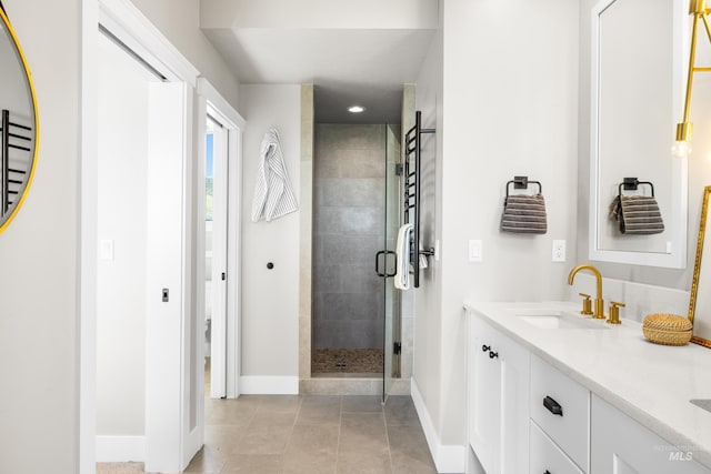 6799 E Warm Springs Ave, Boise, ID 83716 - full bathroom with baseboards, a stall shower, double vanity, and tile patterned floors
