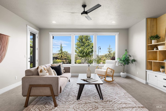 6799 E Warm Springs Ave, Boise, ID 83716 - living room featuring light colored carpet, ceiling fan, baseboards, a textured ceiling, and recessed lighting