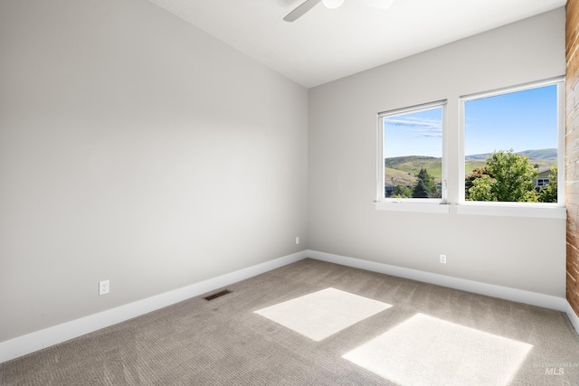6799 E Warm Springs Ave, Boise, ID 83716 - spare room featuring carpet floors, a ceiling fan, and baseboards