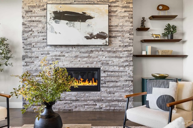 6799 E Warm Springs Ave, Boise, ID 83716 - sitting room featuring wood finished floors, a stone fireplace, and baseboards
