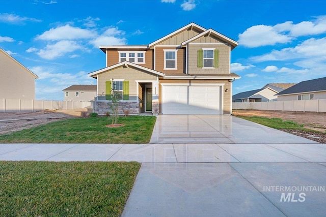 craftsman inspired home featuring a garage and a front lawn