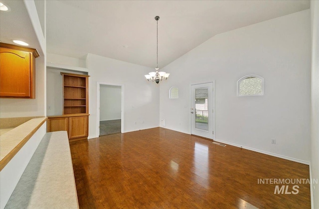 431 N David Frost St, Nampa, ID 83651 - unfurnished dining area with lofted ceiling, a chandelier, dark wood-type flooring, and baseboards