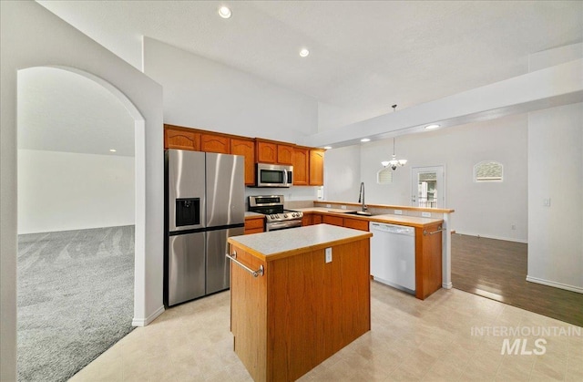 431 N David Frost St, Nampa, ID 83651 - kitchen with stainless steel appliances, a peninsula, a sink, recessed lighting, and a center island