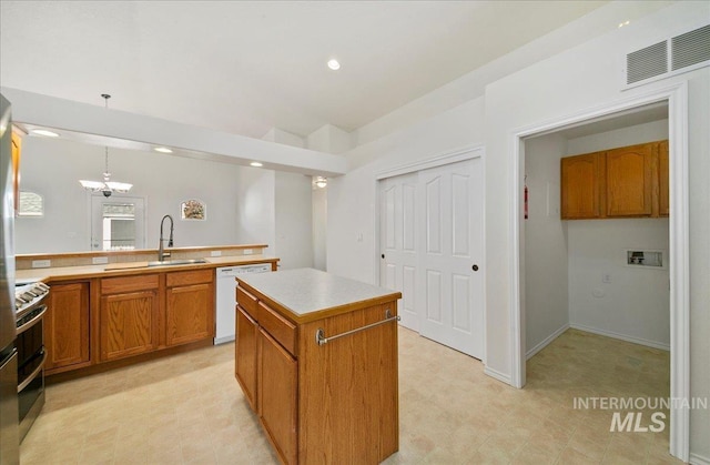 431 N David Frost St, Nampa, ID 83651 - kitchen featuring dishwasher, a sink, range with two ovens, brown cabinetry, and light countertops