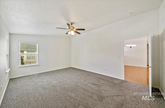 431 N David Frost St, Nampa, ID 83651 - spare room featuring carpet, ceiling fan, a chandelier, baseboards, and a textured ceiling