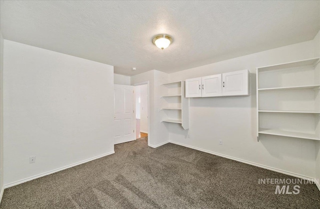 431 N David Frost St, Nampa, ID 83651 - empty room featuring dark colored carpet, baseboards, and a textured ceiling