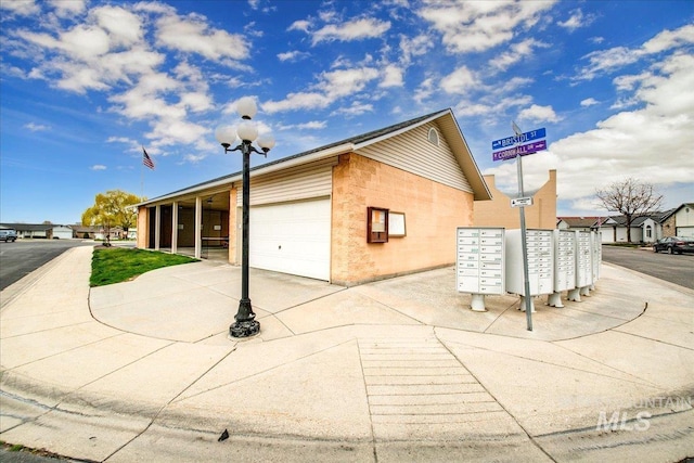 431 N David Frost St, Nampa, ID 83651 - view of side of home featuring mail area and a garage