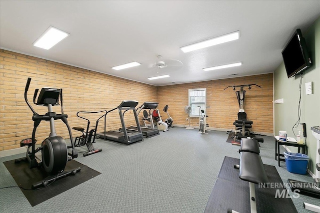431 N David Frost St, Nampa, ID 83651 - gym with wooden walls, baseboards, brick wall, and ceiling fan