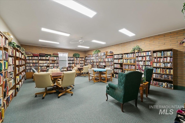 431 N David Frost St, Nampa, ID 83651 - sitting room with bookshelves, brick wall, and carpet floors