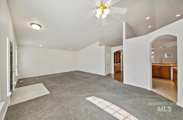 431 N David Frost St, Nampa, ID 83651 - unfurnished living room with arched walkways, carpet floors, a sink, a ceiling fan, and recessed lighting
