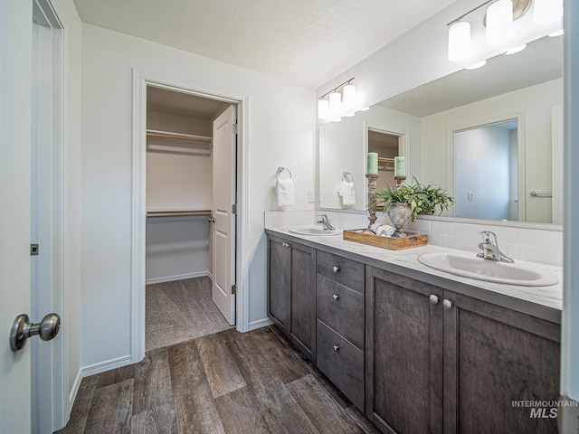 bathroom featuring tasteful backsplash, vanity, and hardwood / wood-style flooring