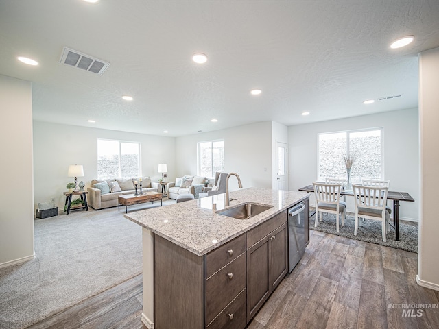 kitchen featuring a kitchen island with sink, sink, plenty of natural light, and dishwasher