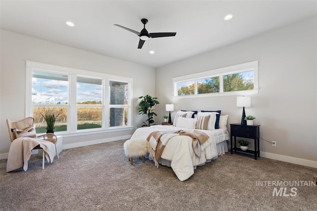 bedroom featuring ceiling fan, carpet flooring, and multiple windows