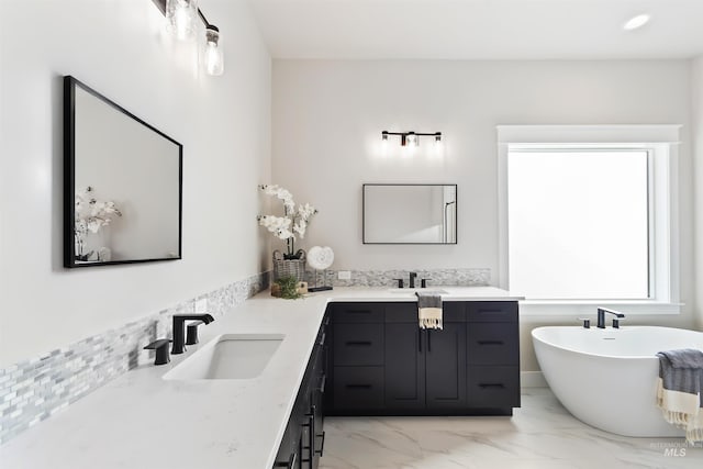 bathroom featuring vanity and a tub to relax in