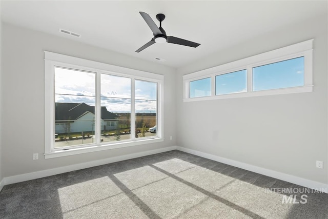 empty room featuring carpet floors and ceiling fan