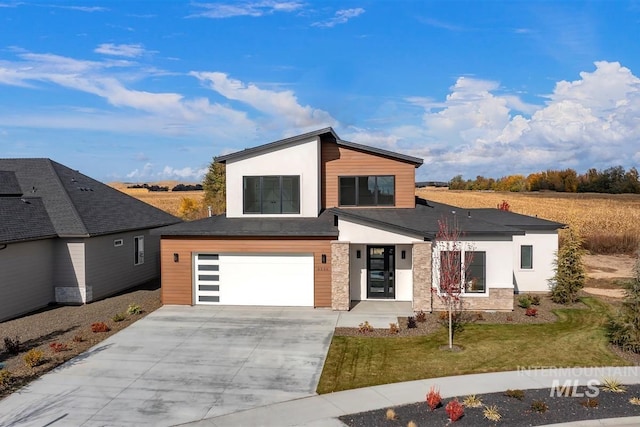 contemporary house featuring a front yard and a garage