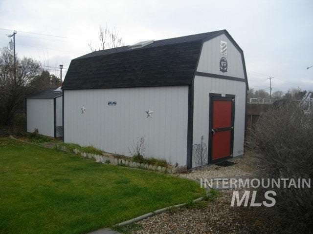 view of outdoor structure featuring a lawn