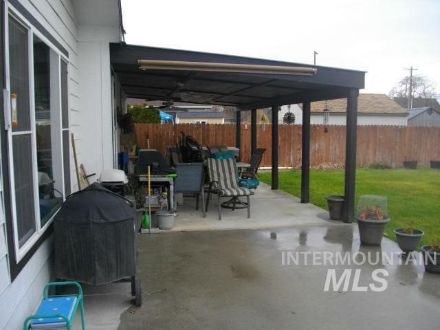 view of patio / terrace featuring area for grilling and fence