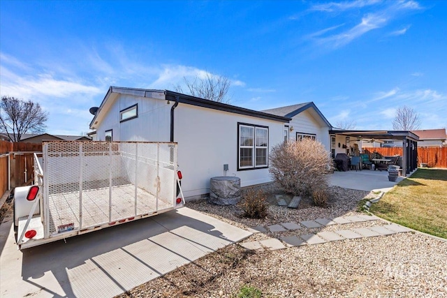 view of side of property featuring a patio and fence